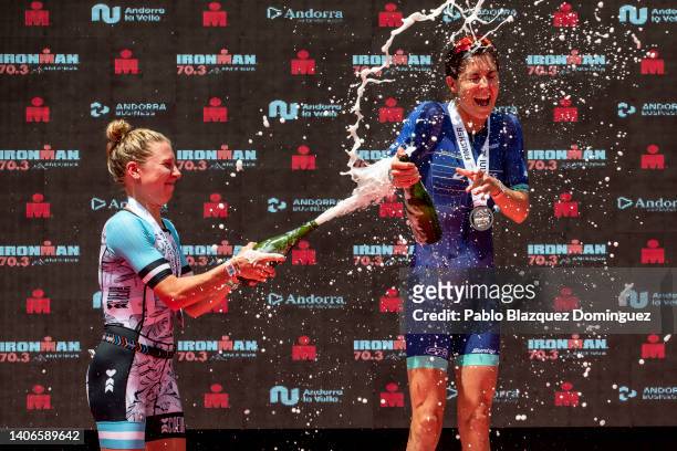 Athletes Ashleigh Gentle of Australia and Amy Cymerman of United States celebrate their results on the podium of women's IRONMAN 70.3 Andorra on July...