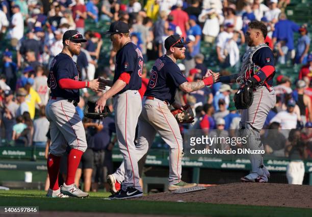 Christian Arroyo, Jake Diekman, Alex Verdugo and Christian Vazquez of the Boston Red Sox celebrate a 4-2 win over the Chicago Cubs on July 03, 2022...