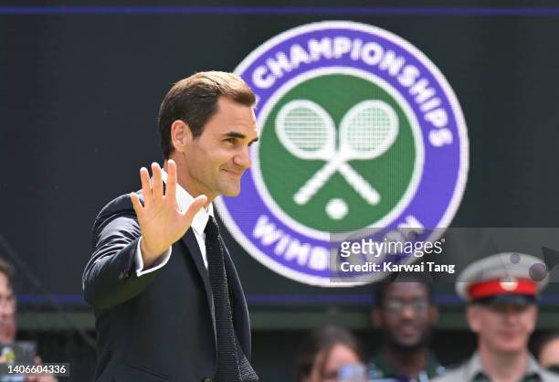 Roger Federer of Switzerland acknowledges spectators at the Centre Court Centenary Celebration on day seven of the Wimbledon Tennis Championships at...