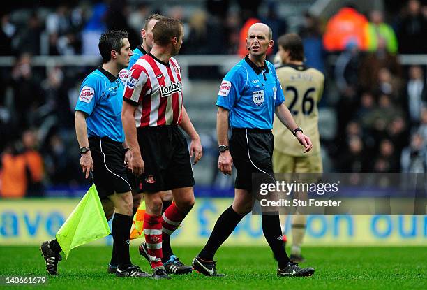 Sunderland captain Lee Cattermole has words with referee Mike Dean before being sent off after the Barclays Premier League match between Newcastle...