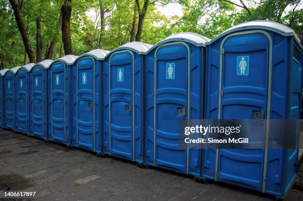 plastic portable toilets for females in a row on a side walk - portable toilet stock pictures, royalty-free photos & images