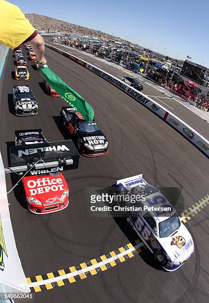 Mark Martin, driver of the Aaron's Toyota, takes the green flag to start the NASCAR Sprint Cup Series SUBWAY Fresh Fit 500 at Phoenix International...