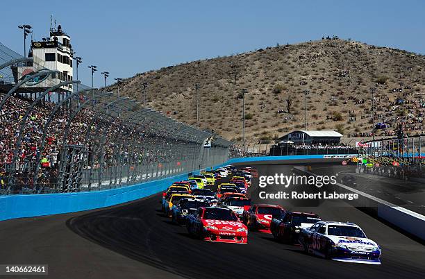 Mark Martin, driver of the Aaron's Toyota, leads the first lap of the NASCAR Sprint Cup Series SUBWAY Fresh Fit 500 at Phoenix International Raceway...