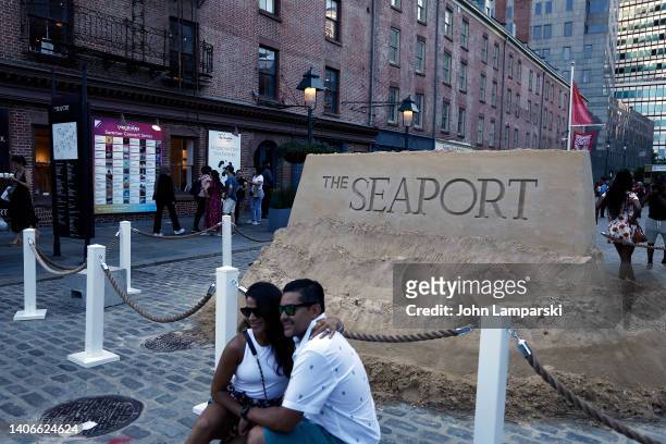 People gather at a sand sculpture at the South Street Seaport during Independence Day weekend on July 03, 2022 in New York City.