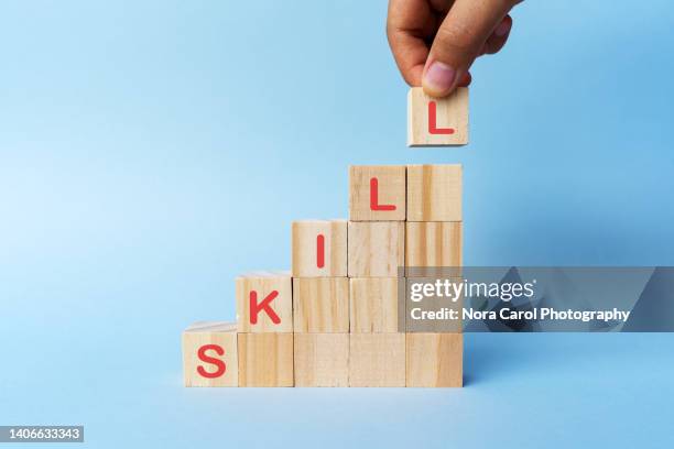 hand holding a wood block with skill text - talent stockfoto's en -beelden