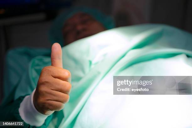 surgeons are working at operating room. - green glove stock pictures, royalty-free photos & images