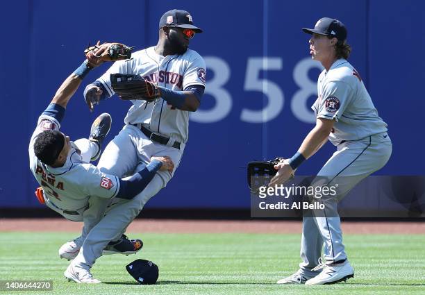 Jeremy Pena crashes into Yordan Alvarez of the Houston Astros while making a catch on a hit by Dominic Smith of the New York Mets in the eighth...