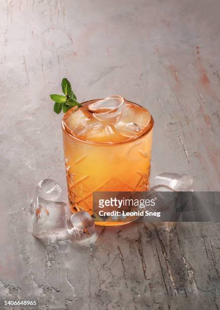 citrus orange cocktail on gray background - grenadine stock pictures, royalty-free photos & images