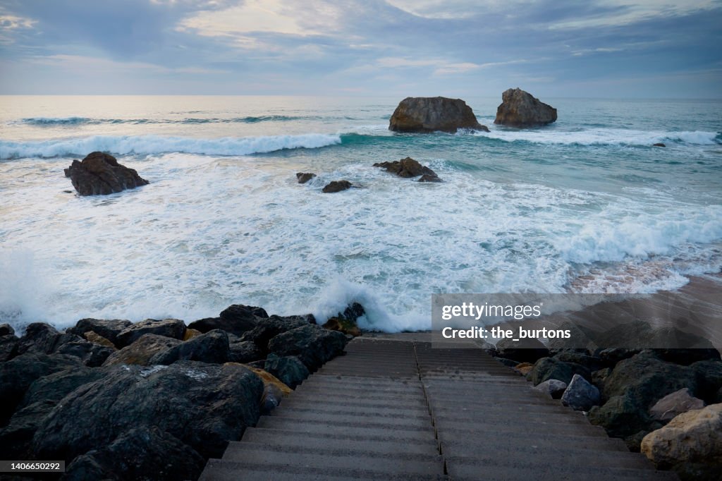 Staircase to the sea and splashing waves