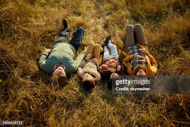 above view of grandparents and grandkids resting in grass. - grandma sleeping stock pictures, royalty-free photos & images