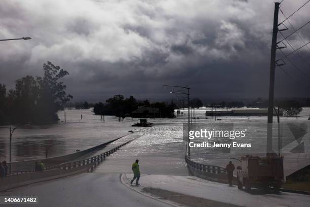 People view the flooded Windsor Bridge along the Hawkesbury River in the suburb of Windsor, on July 04, 2022 in Sydney, Australia. Thousands of...
