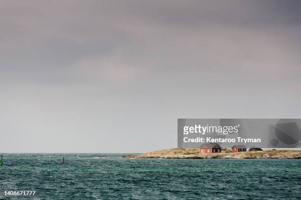 red cottages on a small island in the sea - halland stock pictures, royalty-free photos & images