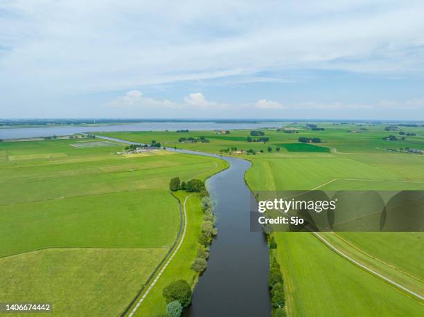rural landscape with a river through the meadows seen from above - polder stock pictures, royalty-free photos & images