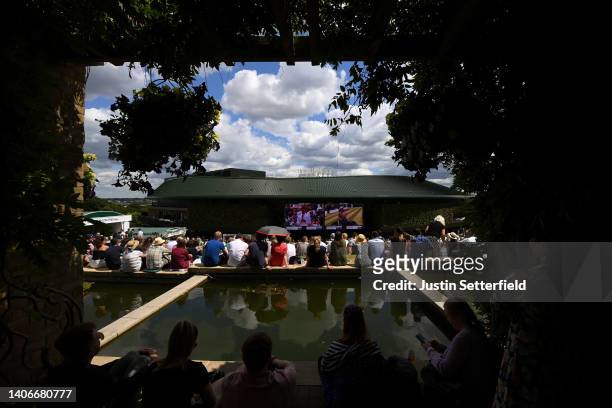 Spectators look over Centre Court from The Hill on day seven of The Championships Wimbledon 2022 at All England Lawn Tennis and Croquet Club on July...