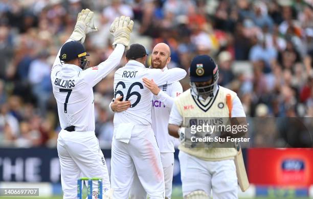 England bowler Jack Leach is congratulated by catcher Joe Root after combining to dismiss India batsman Rishabh Pant rduring day four of the Fifth...