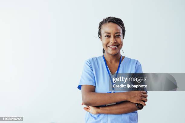 portrait of a young nurse/doctor - woman nurse standing stock pictures, royalty-free photos & images