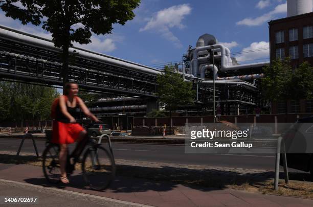 Cyclist rides past the Klingenberg natural gas-powered thermal power station on July 04, 2022 in Berlin, Germany. Germany still receives a large...