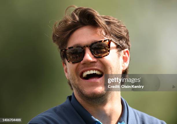 Recording artist Niall Horan shares a joke at the 11th tee during Day One of the JP McManus Pro-Am at Adare Manor on July 04, 2022 in Limerick,...