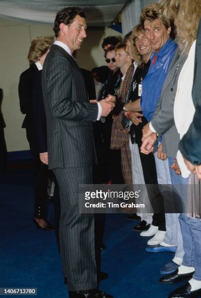 Prince Charles talks to a line of performers including Rod Stewart and Tina Turner at the Prince's Trust All Star Rock concert at the Wembley Arena...