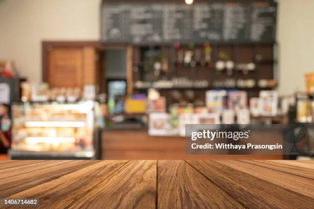 wood table top on blur restaurant interior background - inside coffe store stock pictures, royalty-free photos & images