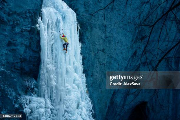 strong ice climber - frozen waterfall stockfoto's en -beelden