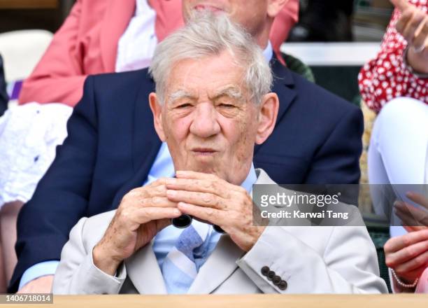 Sir Ian McKellen looks through a pair of binoculars during Day Eight of the Wimbledon Tennis Championships 2022 at All England Lawn Tennis and...