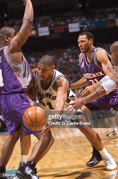 Tim Duncan of the San Antonio Spurs finds a space for the past around Alton Ford of the Phoenix Suns during the 2nd quarter of the game at the...