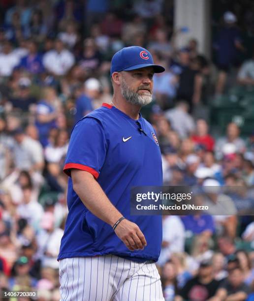 Manager David Ross of the Chicago Cubs walks to the dugout after making a pitching change during the first inning of a game against the Boston Red...