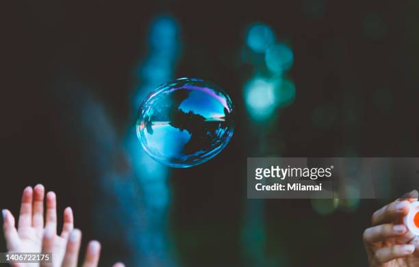 forest, sky and water reflecting in flying soap bubble - bubble wand ストックフォトと画像