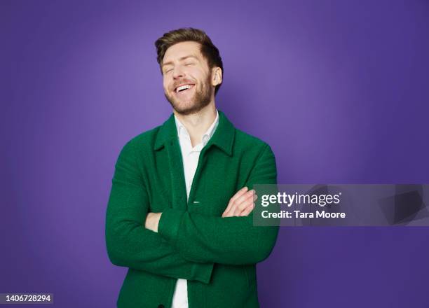 man laughing - studio portrait colour background stock-fotos und bilder