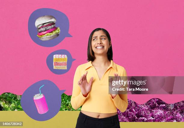 woman rejecting junk food - veleiding stockfoto's en -beelden