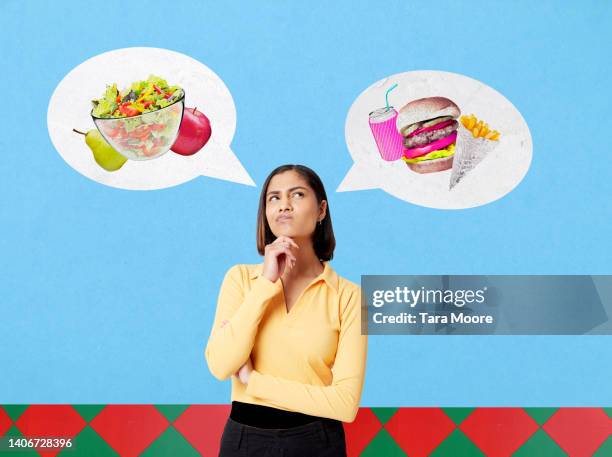 woman choosing between healthy food and junk food - decisions fotografías e imágenes de stock