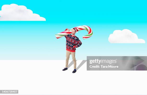 man holding christmas candy cane - christmas montage stock pictures, royalty-free photos & images