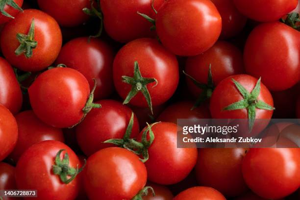 ripe red cherry tomatoes at a retail market or hypermarket. vegetarian, vegan and raw food and diet. organic homemade farm products. harvesting in the garden, vegetable garden, in the country. food background. from the farm to the table. vegetable food. - tomate fotografías e imágenes de stock