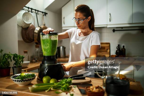 it's always a good time for a healthy and fresh green detox smoothie - cutting green apple stock pictures, royalty-free photos & images