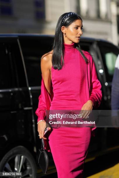 Guest wears a black shiny leather nailed / studded headband, silver earrings, a neon pink high neck / sleeveless midi tube dress, a matching neon...