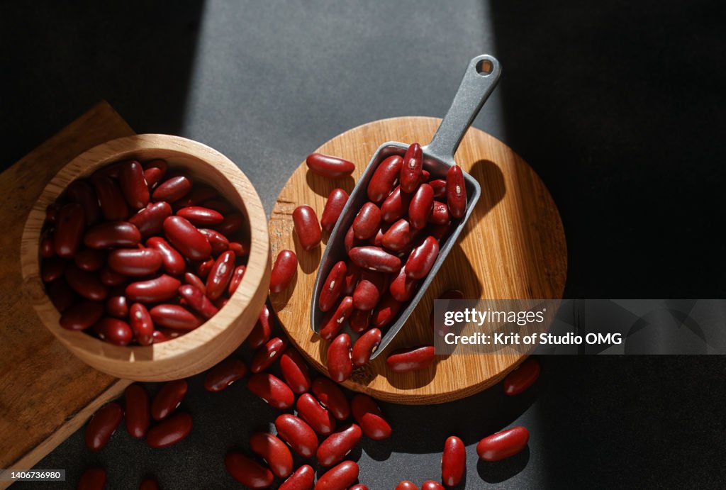 Kidney beans in a wooden bowl and metal shovel
