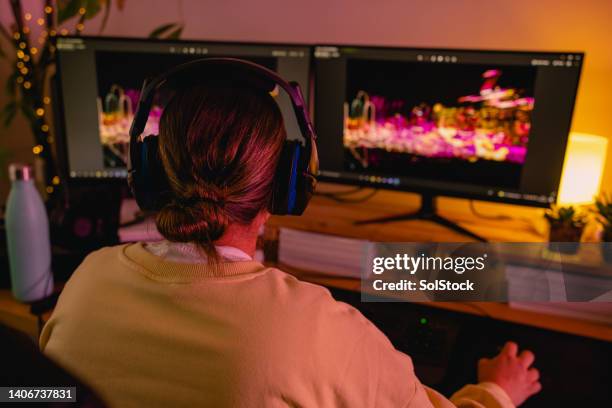 playing her favourite computer game - back of office chair stock pictures, royalty-free photos & images