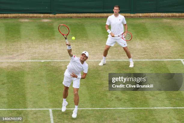 Wesley Koolhof of Netherlands plays a smash as partner Neal Skupski of Great Britain looks on against Matthew Ebden and Max Purcell of Australia...