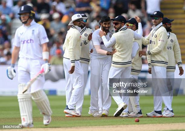 England batsman Ollie Pope leaves the crease as Jasprit Bumrah is congratulated by team mates after taking his wicket during day four of the Fifth...