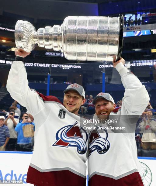 Erik Johnson and J.T. Compher of the Colorado Avalanche hold the Stanley Cup following their victory over the Tampa Bay Lightning in Game Six of the...