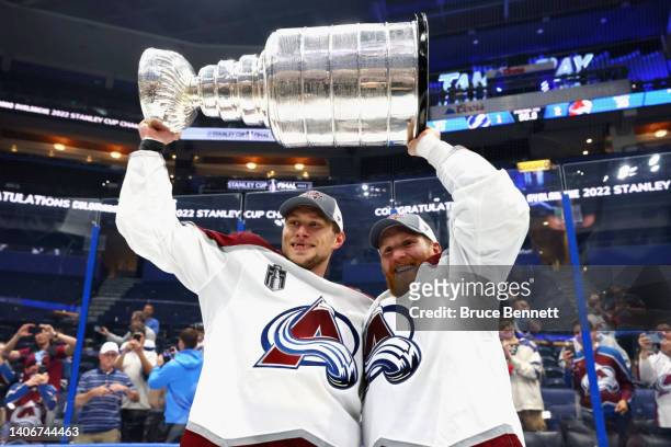 Erik Johnson and J.T. Compher of the Colorado Avalanche hold the Stanley Cup following their victory over the Tampa Bay Lightning in Game Six of the...