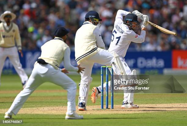 England batsman Jonny Bairstow cuts a ball towards the boundary watched by Rishabh Pant during day four of the Fifth test match between England and...