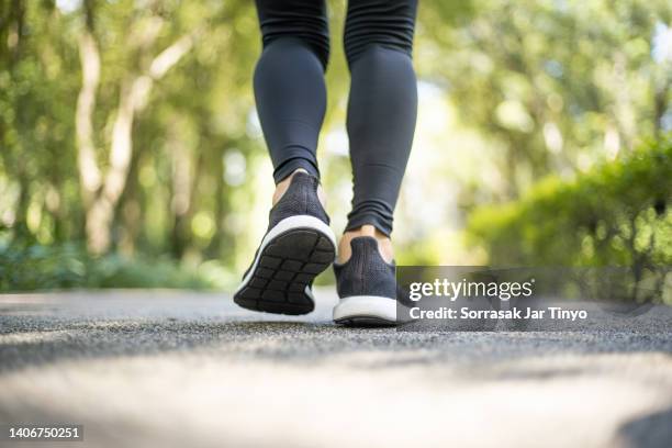 close up of young athlete women feet in running activity - walking photos et images de collection