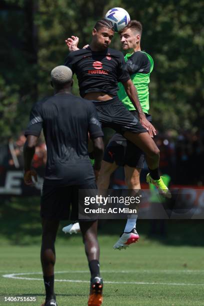 Emil Pakebba Joof Roback of AC Milan is challenged by Matteo Gabbia during a AC Milan training session at Milanello on July 04, 2022 in Cairate,...