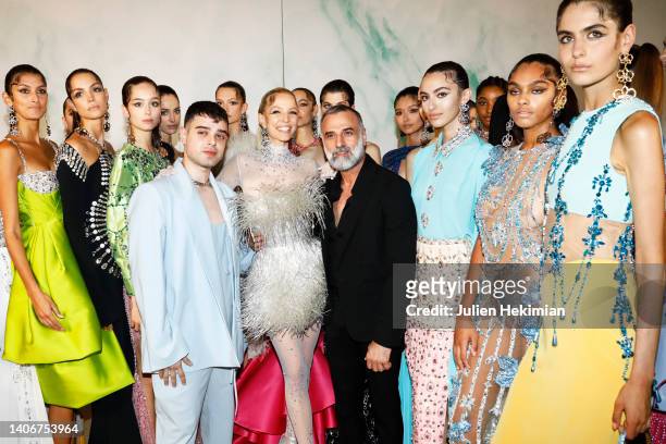 Georges Hobeika and his son Jad Hobeika are pictured backstage with models at the end of the Georges Hobeika Haute Couture Fall Winter 2022 2023 show...