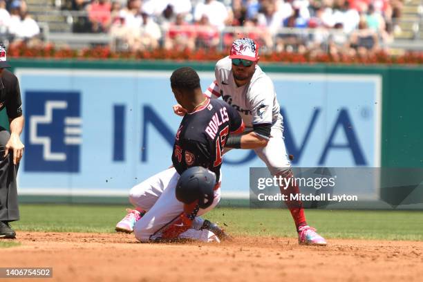 Miguel Rojas of the Miami Marlins takes Victor Robles of the Washington Nationals trying to stretch a single single in the forth inning during a...