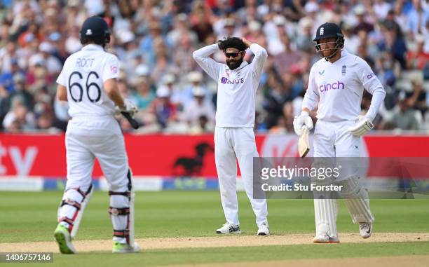 India bowler Ravindra Jadeja reacts as England batsmen Jonny Bairstow and Joe Root pick up some ru during day four of the Fifth test match between...