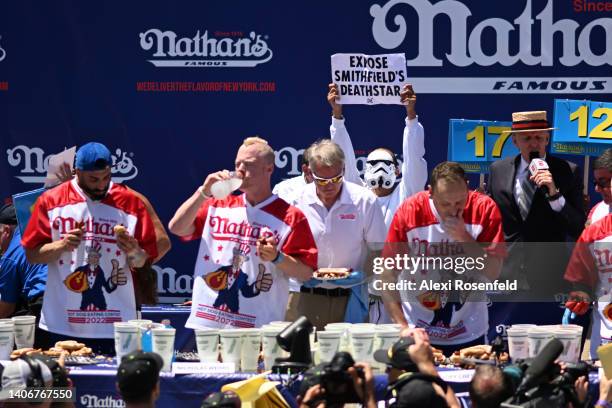 Protestor interrupts defending champion Joey Chestnut competing in the 2022 Nathans Famous Fourth of July International Hot Dog Eating Contest at...