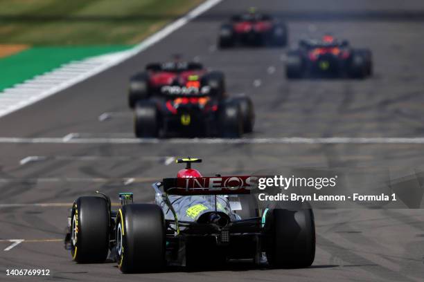 Lewis Hamilton of Great Britain driving the Mercedes AMG Petronas F1 Team W13 makes his way to the grid for the start of the F1 Grand Prix of Great...